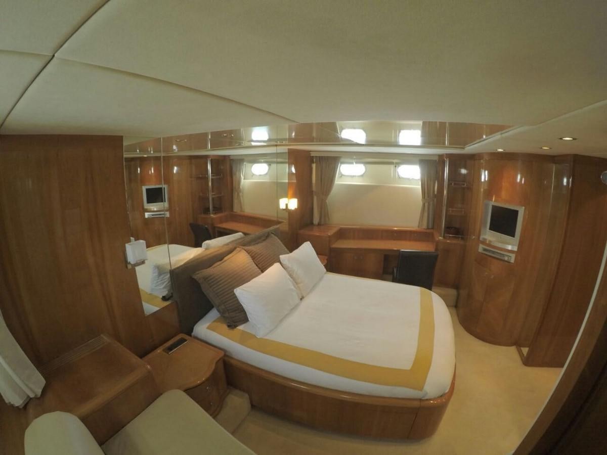 a room with a bed and a mirror aboard AZIMUT 100' Yacht for Sale
