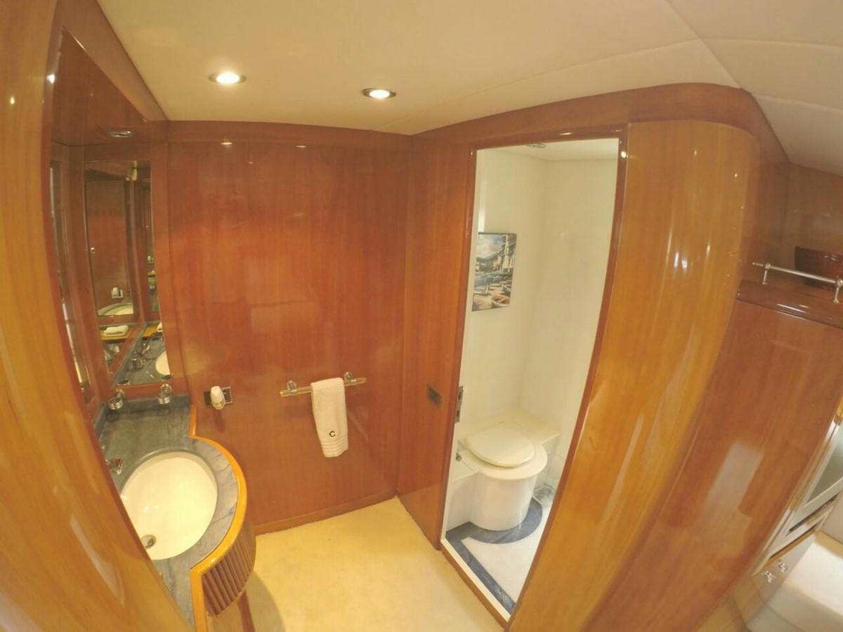 a bathroom with a toilet and a sink aboard AZIMUT 100' Yacht for Sale