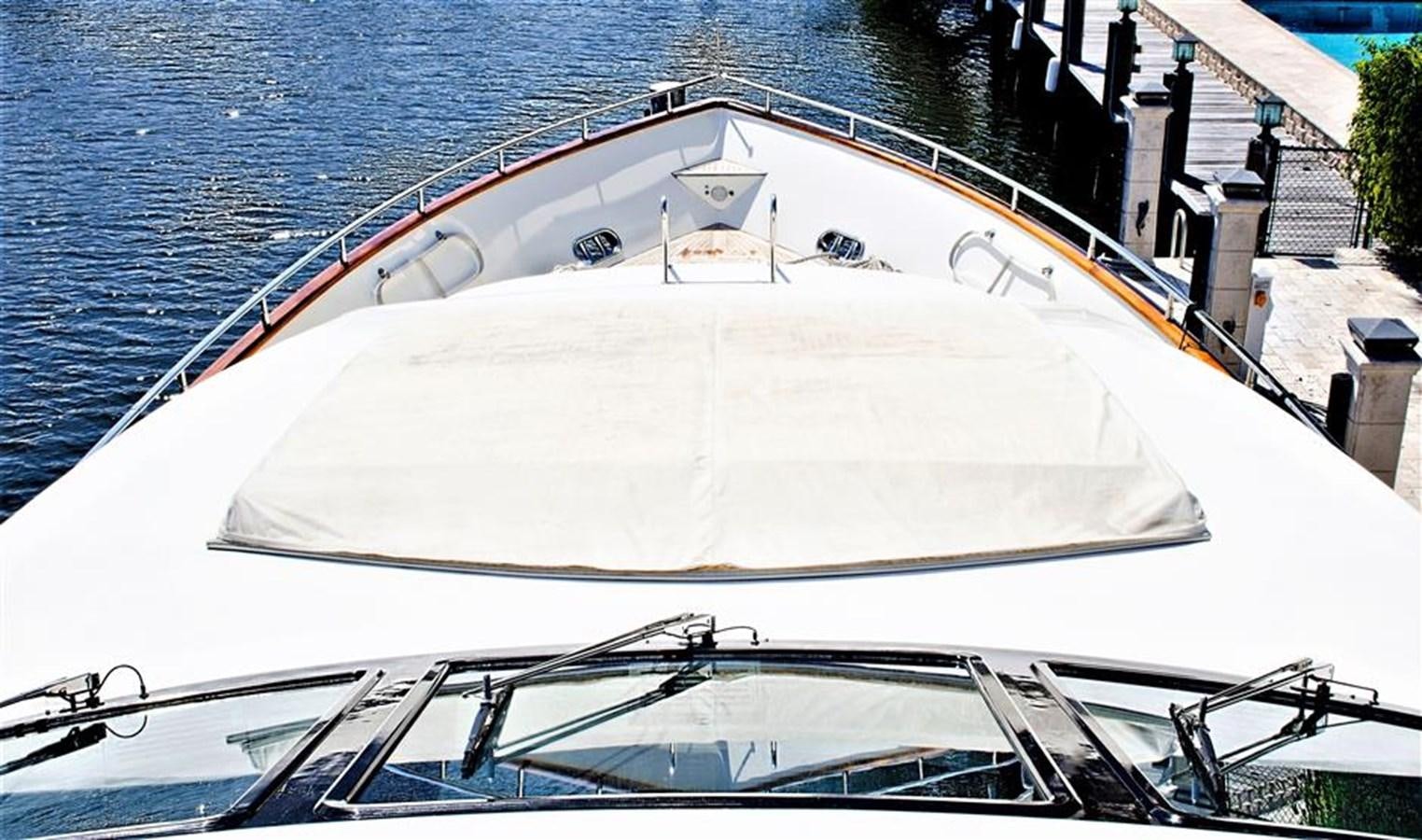 a white boat on a dock aboard CAROBELLE Yacht for Sale