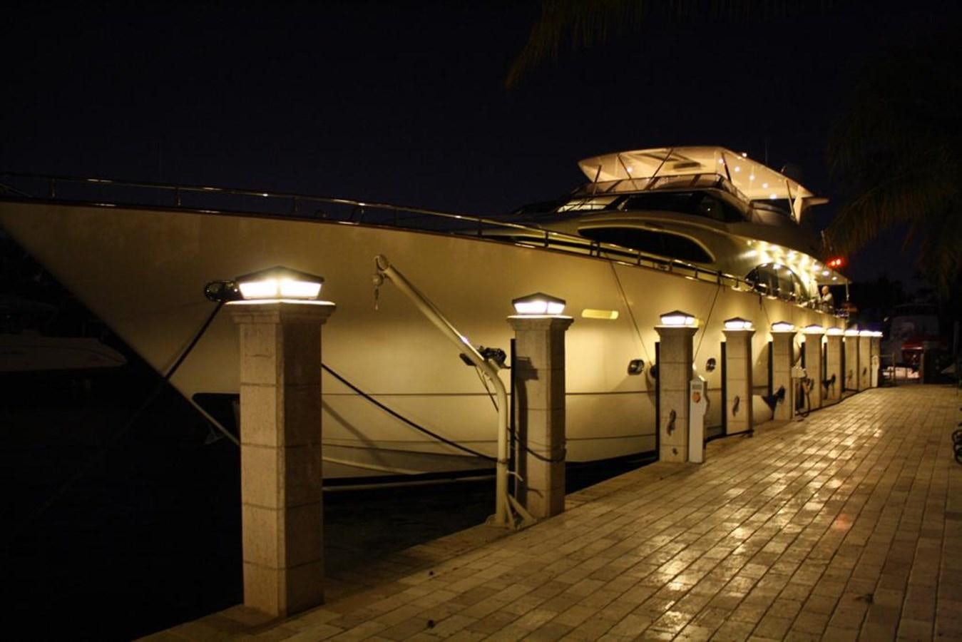 a building with lights at night aboard CAROBELLE Yacht for Sale