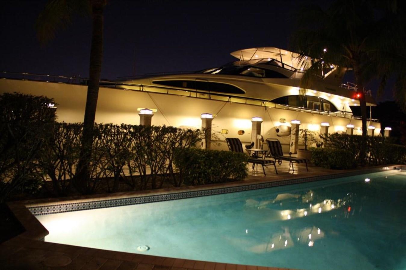 a swimming pool with a large building in the background aboard CAROBELLE Yacht for Sale