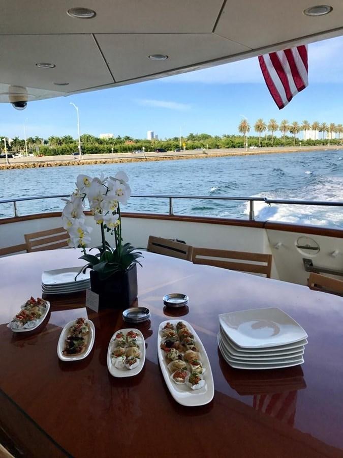 a table with plates and flowers on it aboard CAROBELLE Yacht for Sale