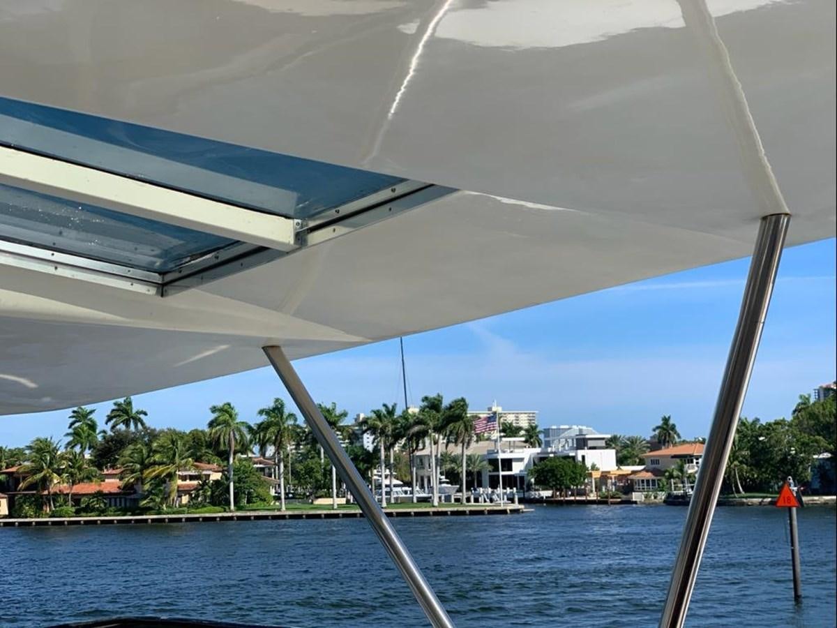 a view of a beach from a window of a building aboard CAROBELLE Yacht for Sale