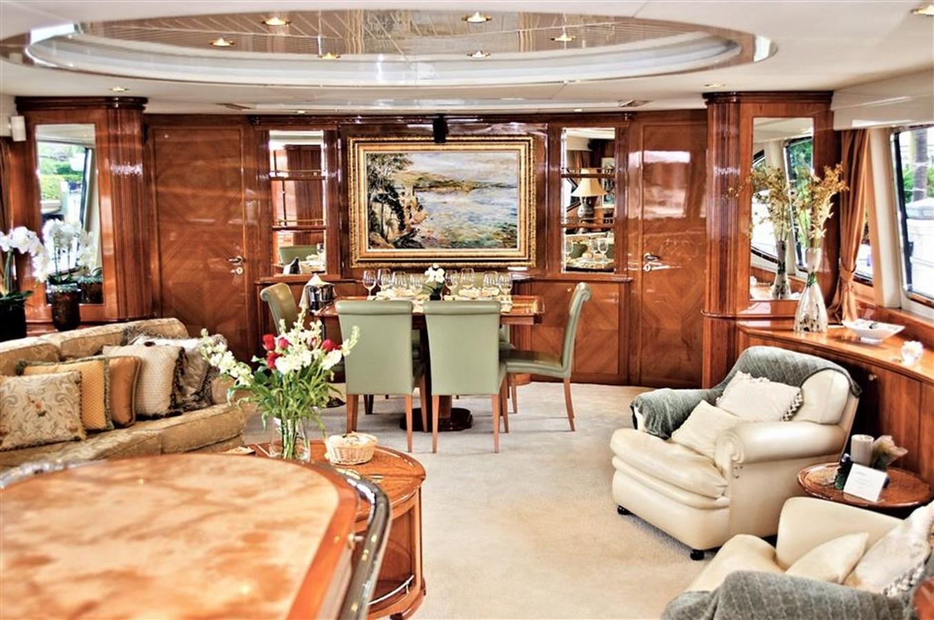 a living room with a table and chairs aboard CAROBELLE Yacht for Sale
