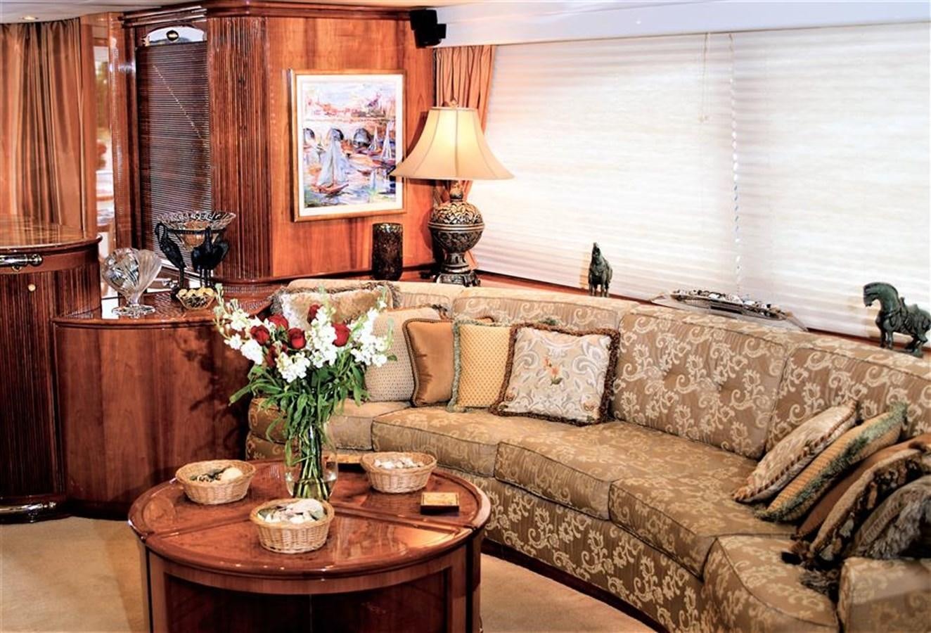 a living room with a couch and a table aboard CAROBELLE Yacht for Sale