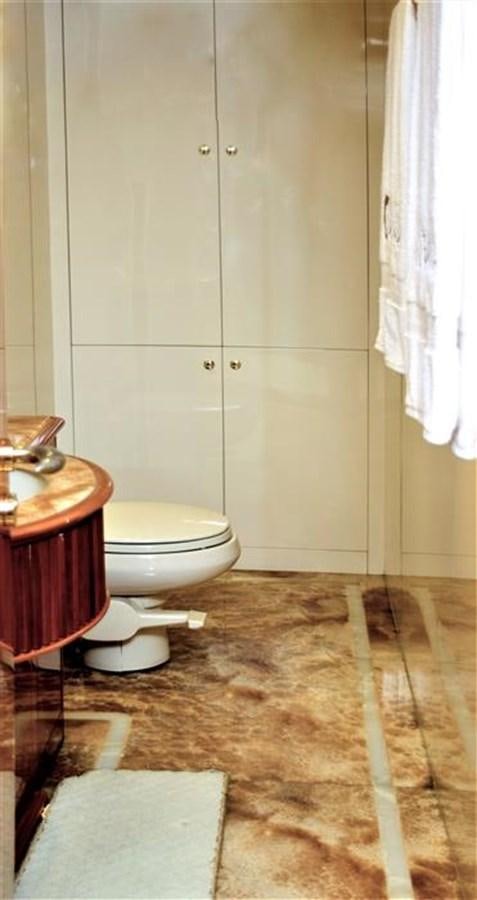a bathroom with a toilet and sink aboard CAROBELLE Yacht for Sale