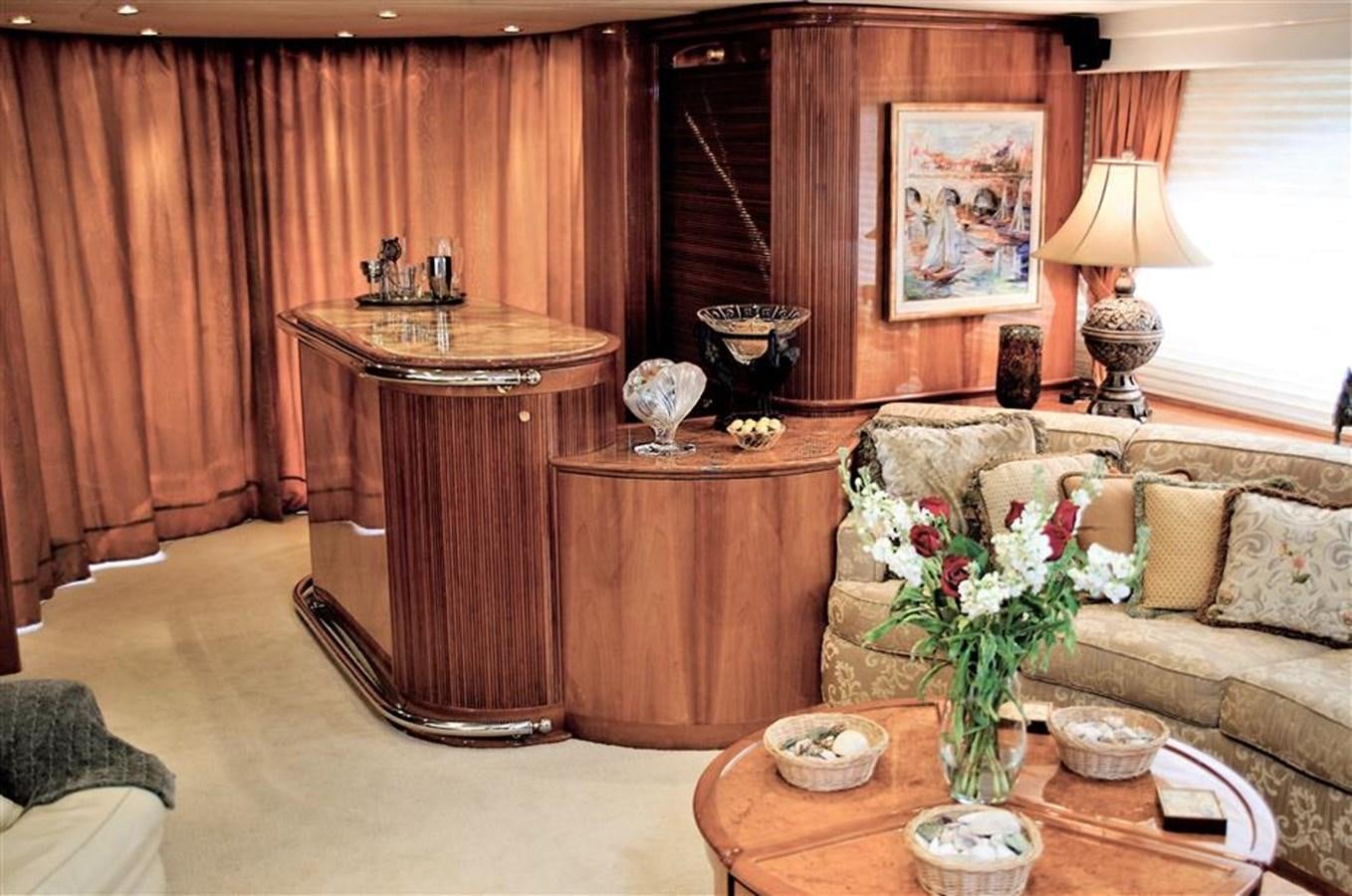 a living room with a couch and a table aboard CAROBELLE Yacht for Sale