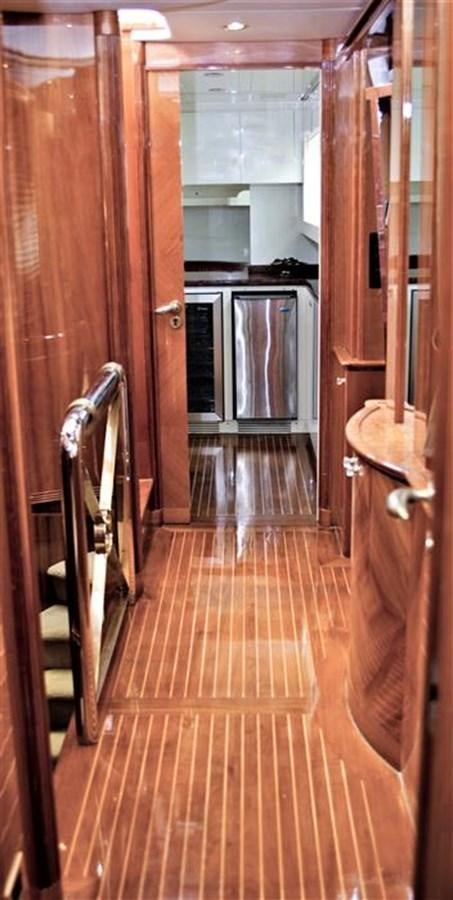 a kitchen with wooden cabinets aboard CAROBELLE Yacht for Sale
