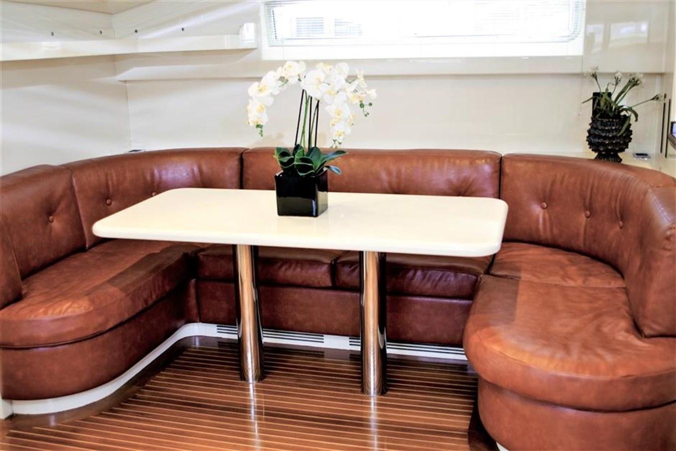 a table with white flowers on it aboard CAROBELLE Yacht for Sale