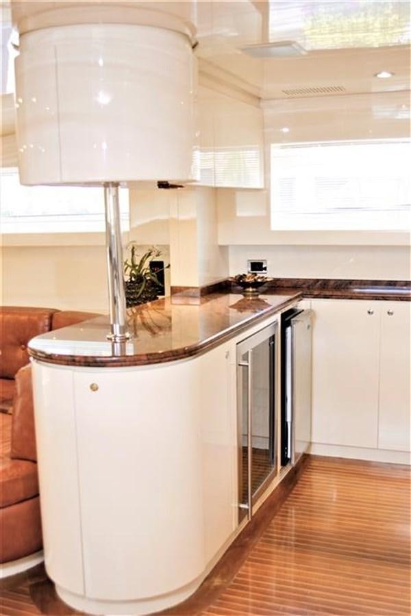 a kitchen with white cabinets aboard CAROBELLE Yacht for Sale