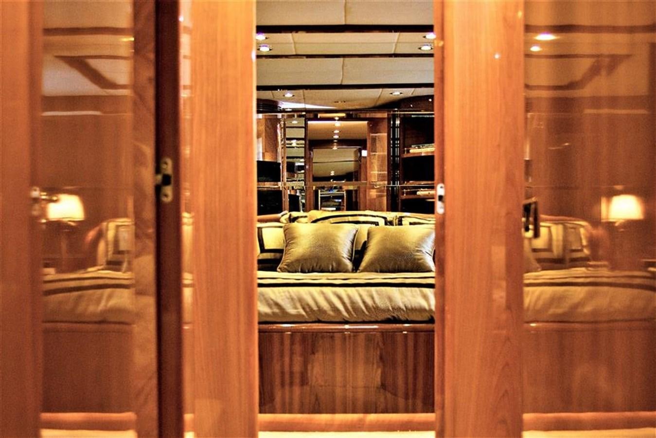 a room with a bed and a window aboard CAROBELLE Yacht for Sale