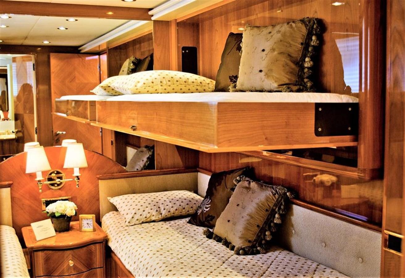 a bed with a wood headboard aboard CAROBELLE Yacht for Sale