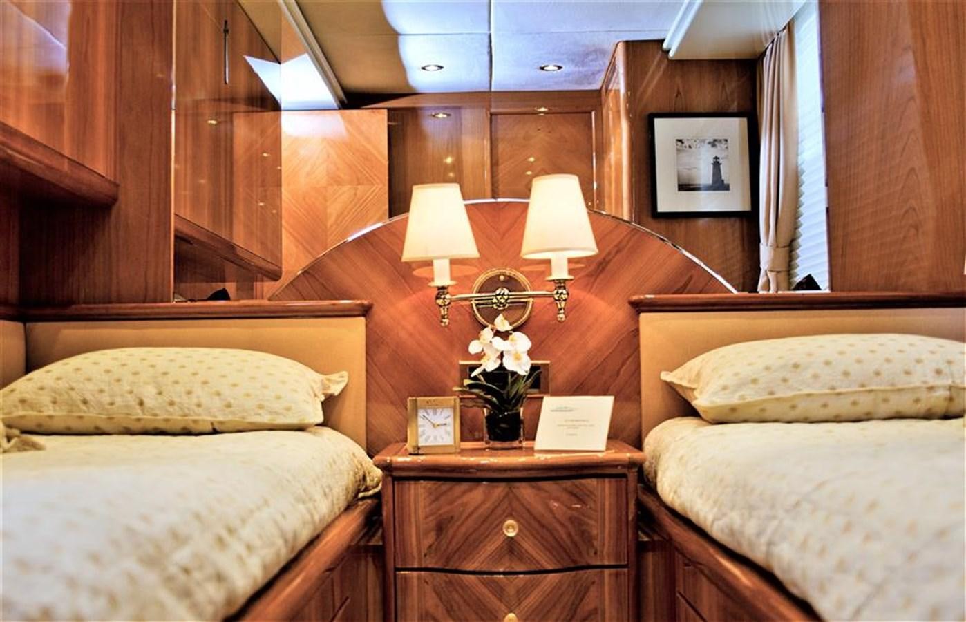 a room with a bed and a lamp aboard CAROBELLE Yacht for Sale