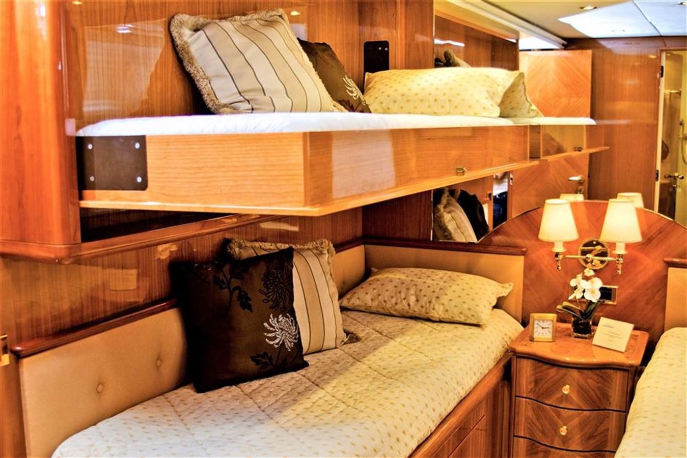 a bed with a wooden headboard aboard CAROBELLE Yacht for Sale