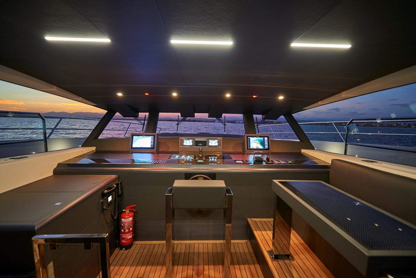 a room with a table and chairs aboard AST100CENROY Yacht for Sale