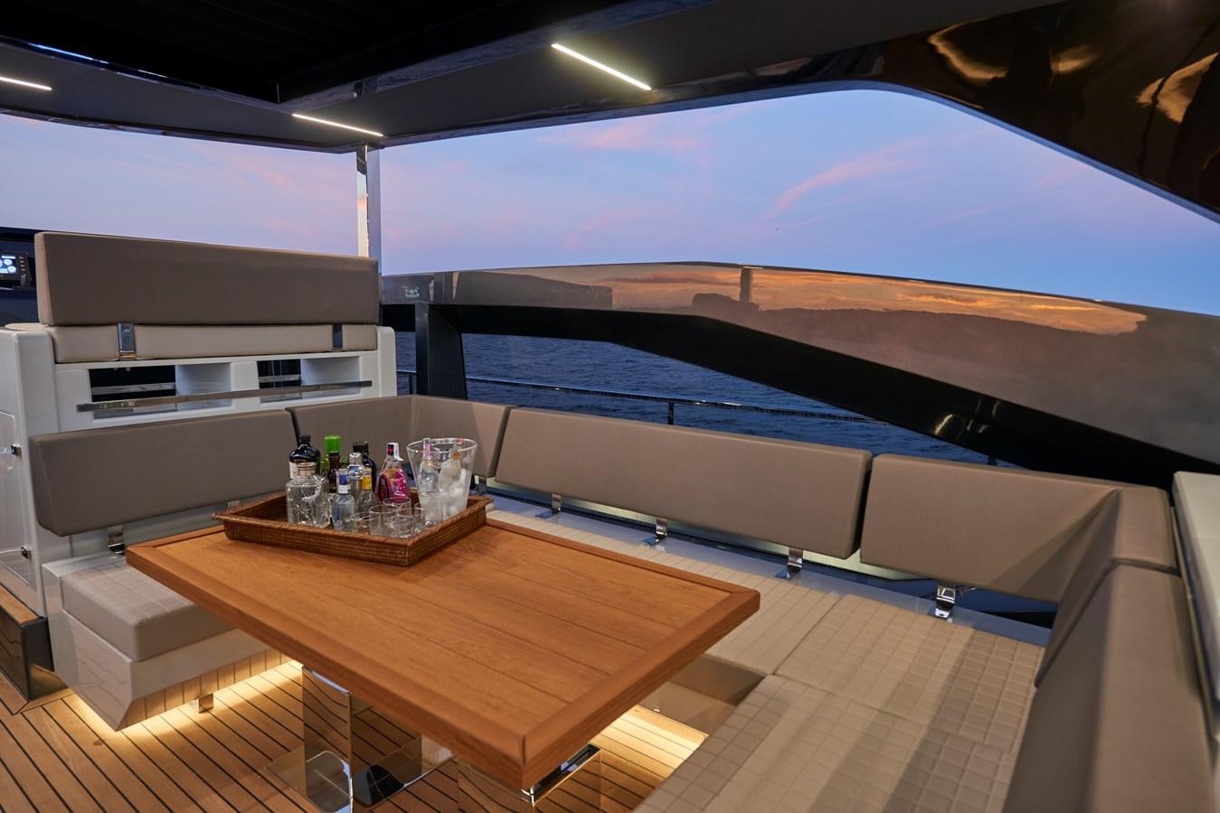 a room with a table and a couch aboard AST100CENROY Yacht for Sale