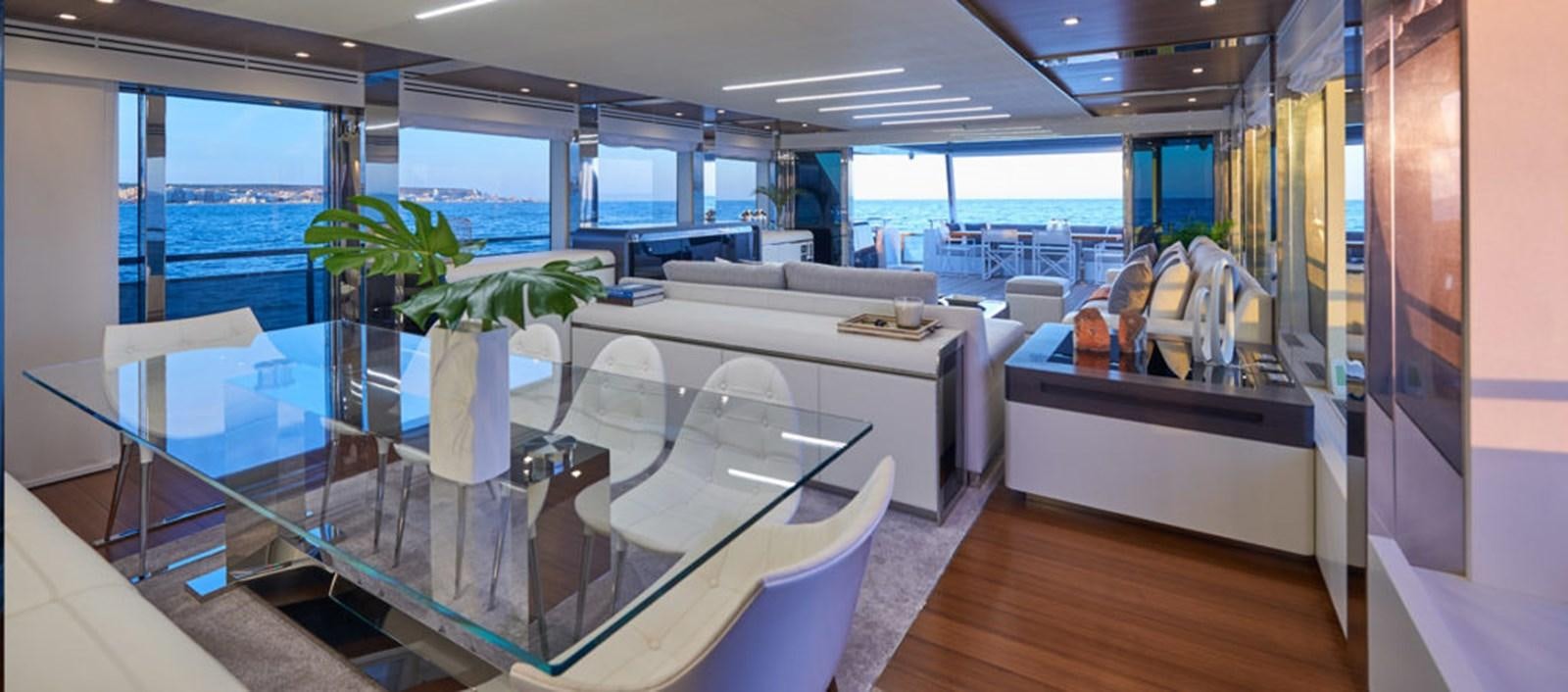 a large room with a table and chairs aboard AST100CENROY Yacht for Sale