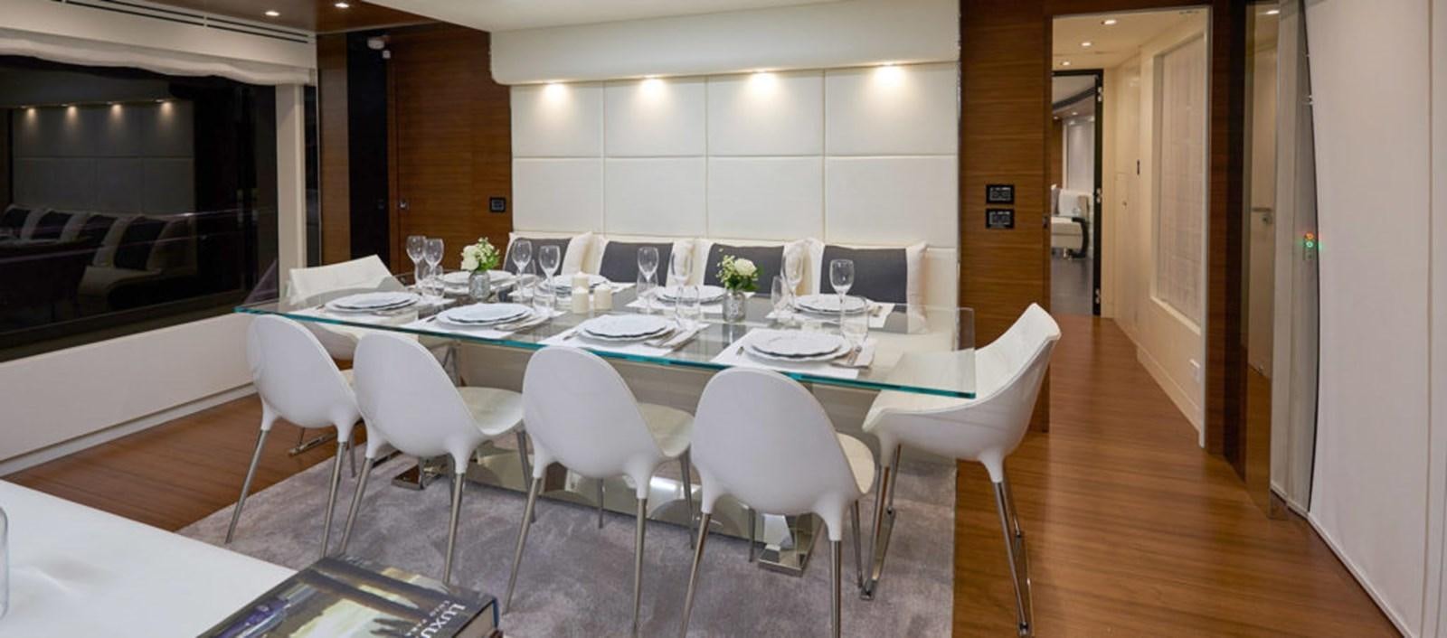 a long table with white chairs aboard AST100CENROY Yacht for Sale