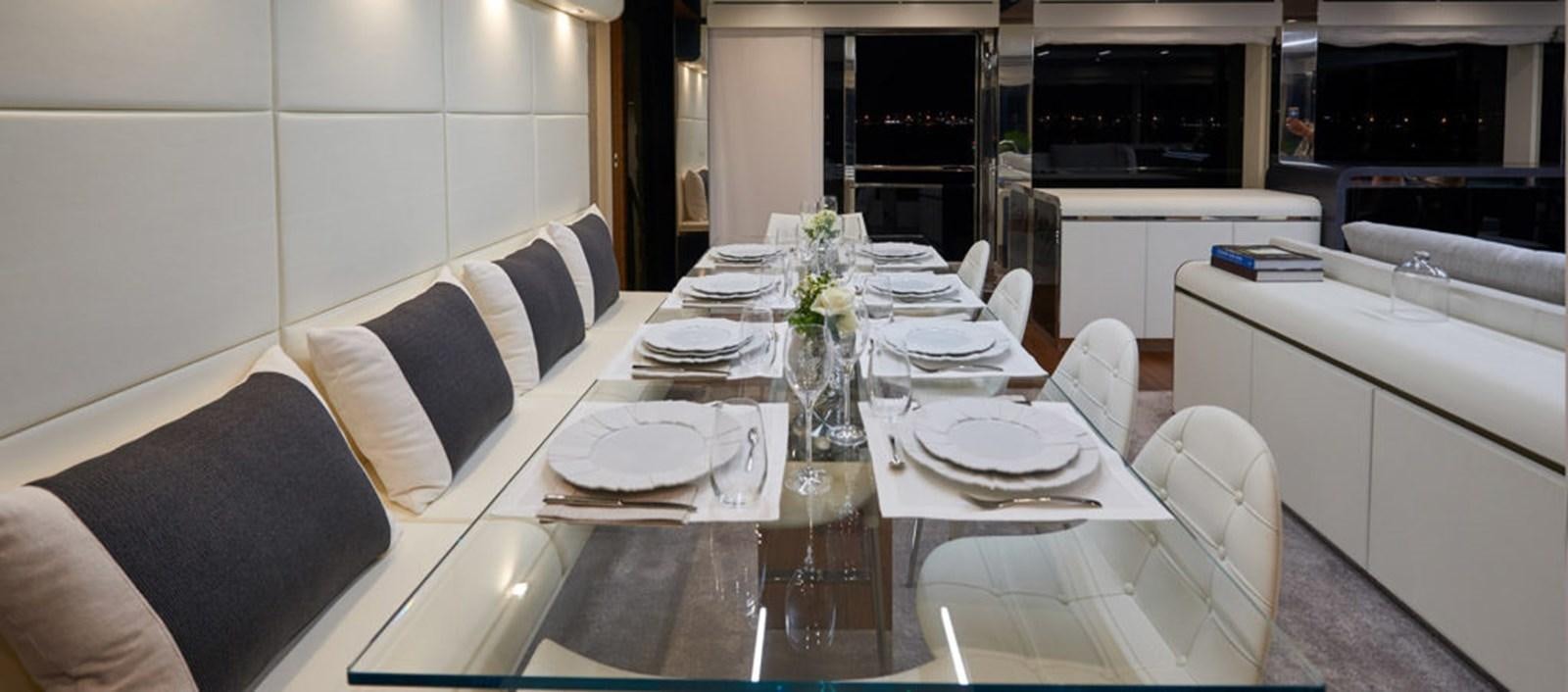 a table with plates and chairs aboard AST100CENROY Yacht for Sale