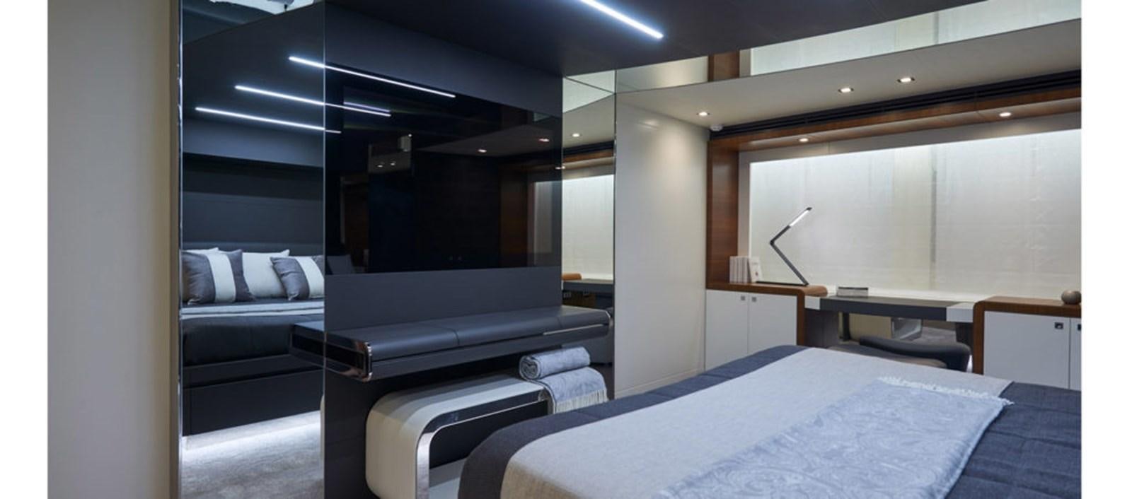 a room with a bed and a desk aboard AST100CENROY Yacht for Sale