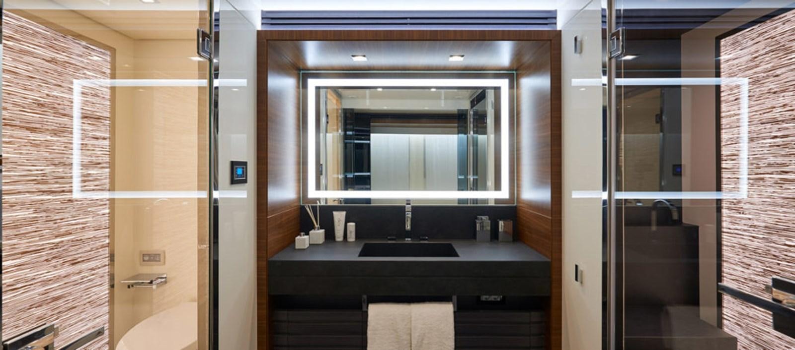 a bathroom with a sink and a mirror aboard AST100CENROY Yacht for Sale