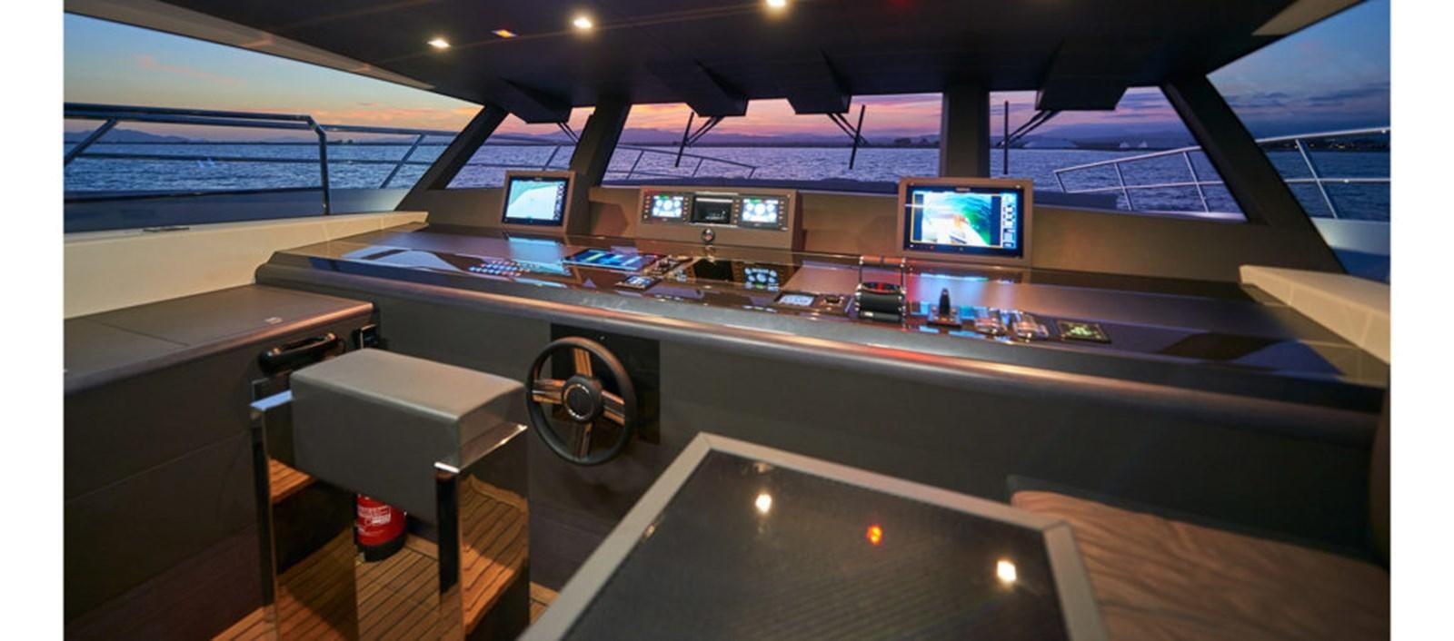 a table with a computer on it aboard AST100CENROY Yacht for Sale