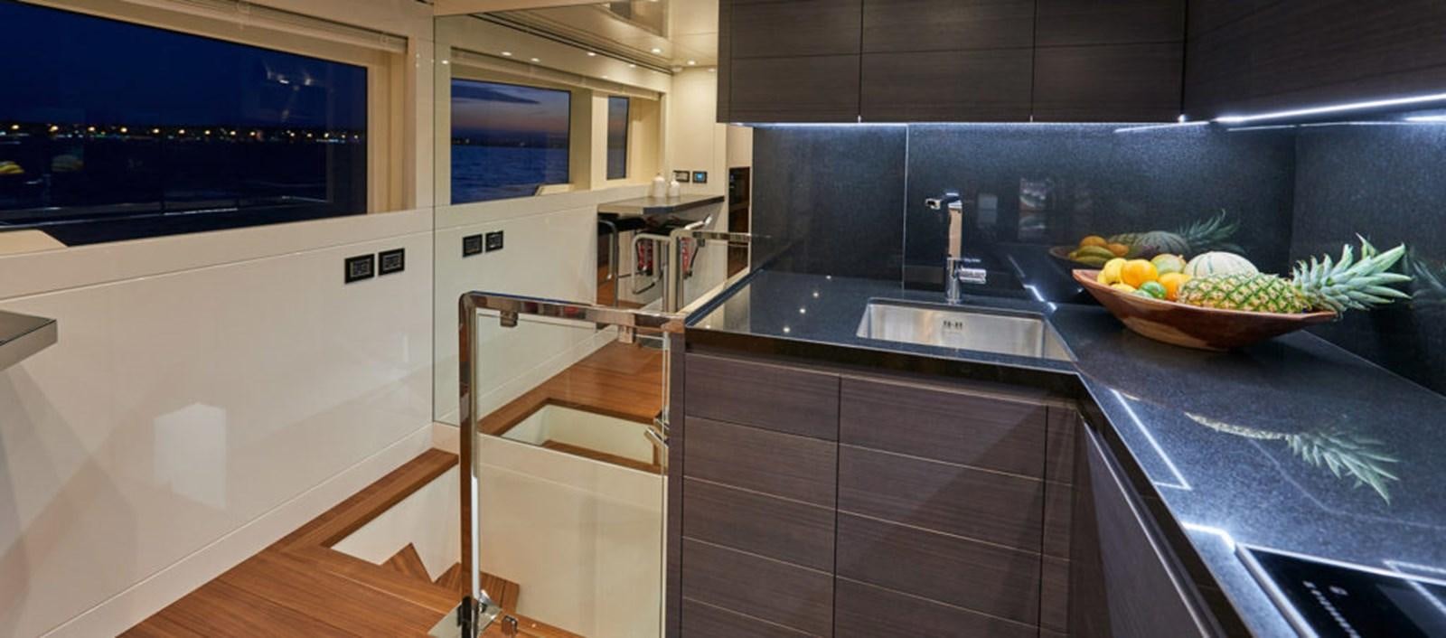 a kitchen with a large island aboard AST100CENROY Yacht for Sale