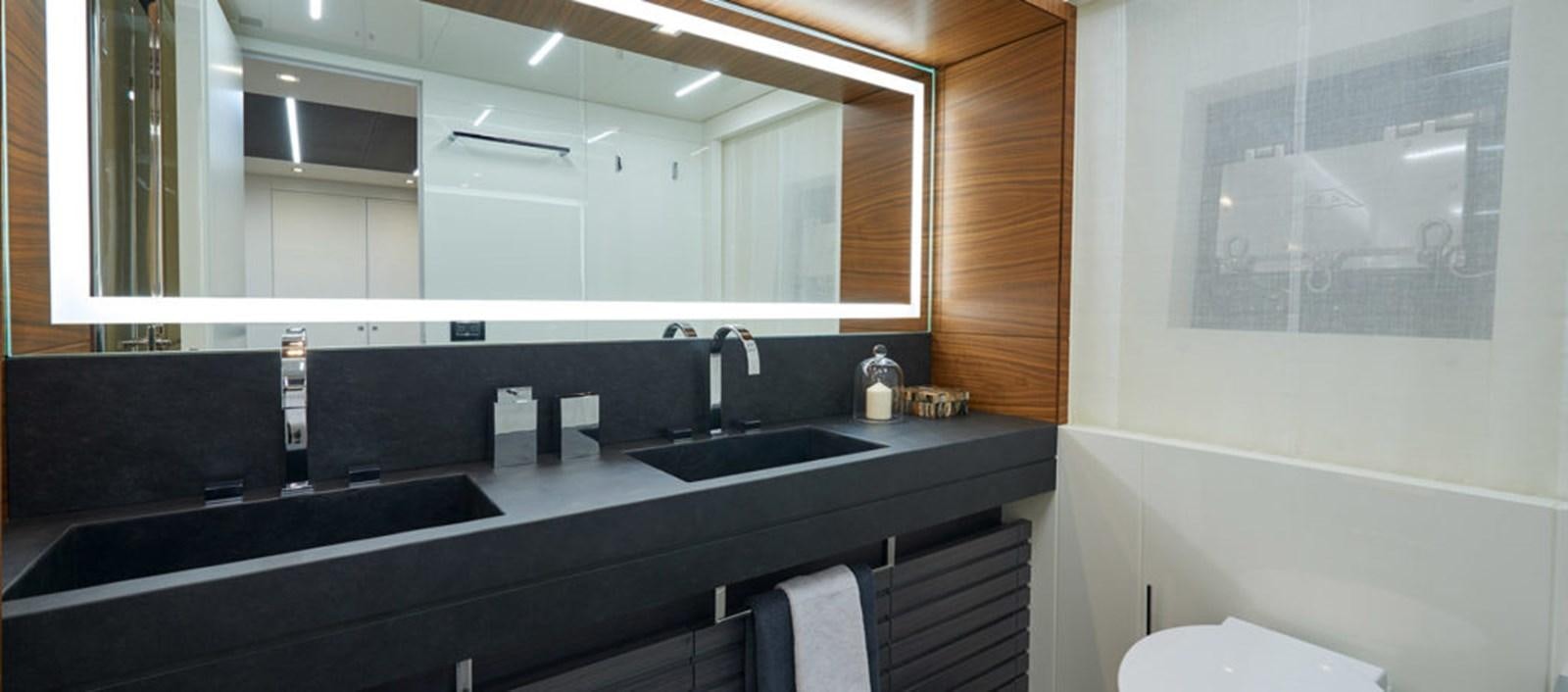 a bathroom with a large mirror aboard AST100CENROY Yacht for Sale