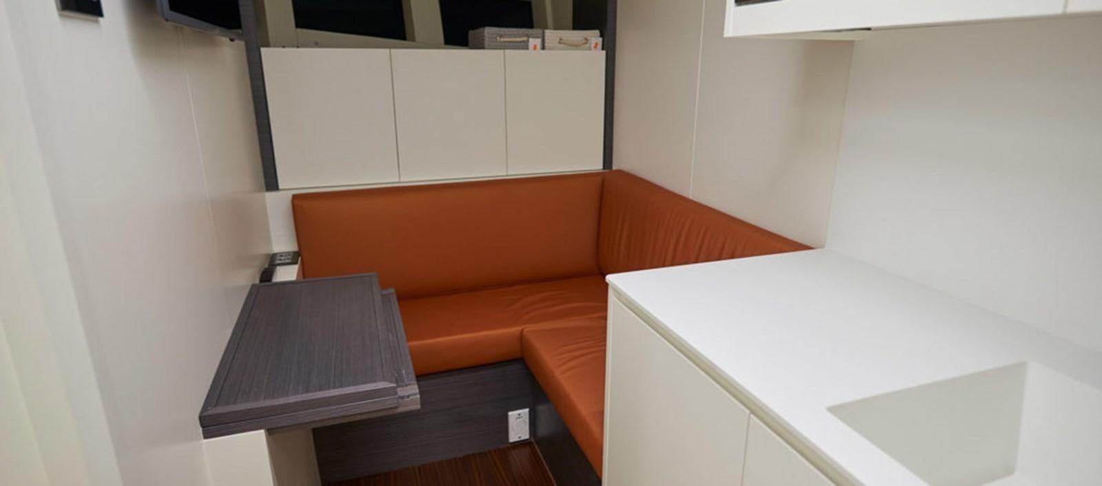a couch and a table in a room aboard AST100CENROY Yacht for Sale