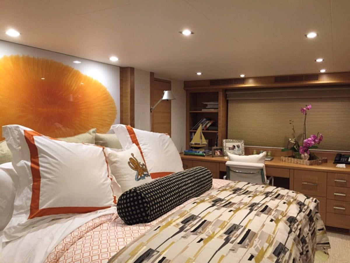 a bedroom with a bed and a desk aboard MAGALITA V Yacht for Sale