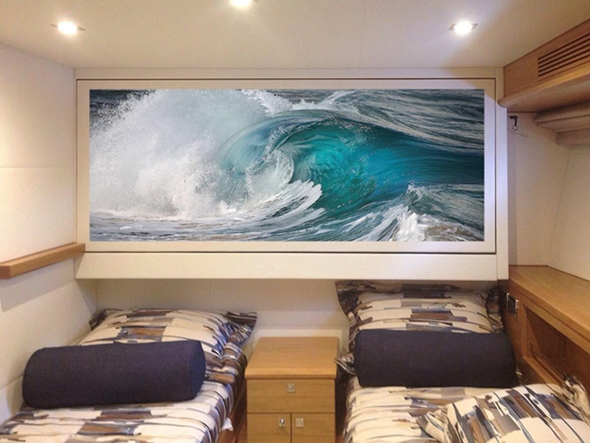 a large blue fish tank in a bedroom aboard MAGALITA V Yacht for Sale