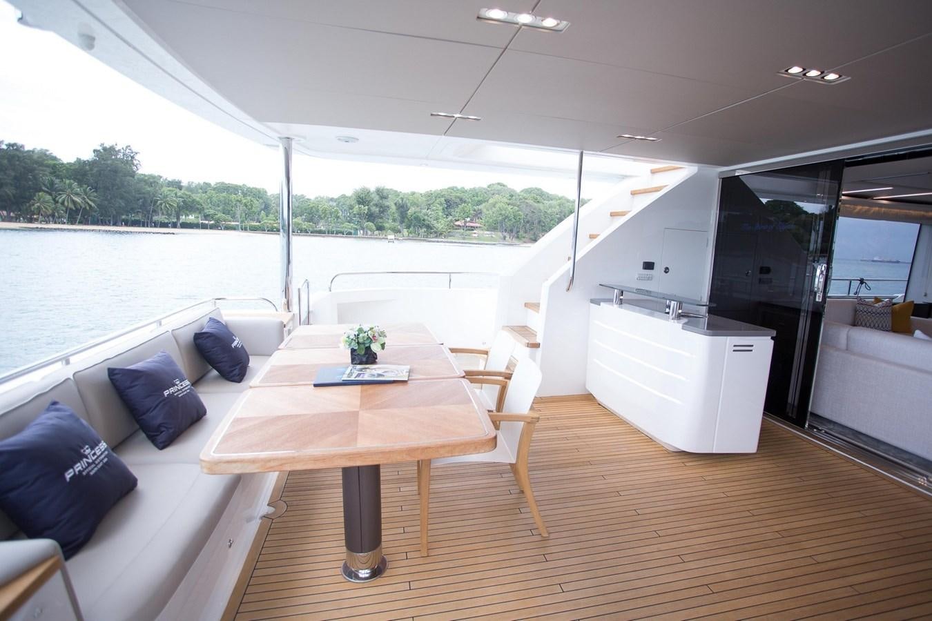 a living room with a table and chairs aboard THE SPIRIT OF ELIJAH Yacht for Sale
