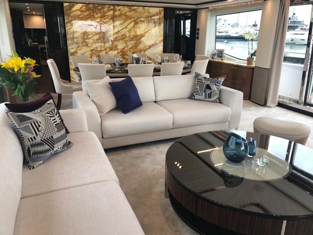 a living room with white couches and a table aboard THE SPIRIT OF ELIJAH Yacht for Sale