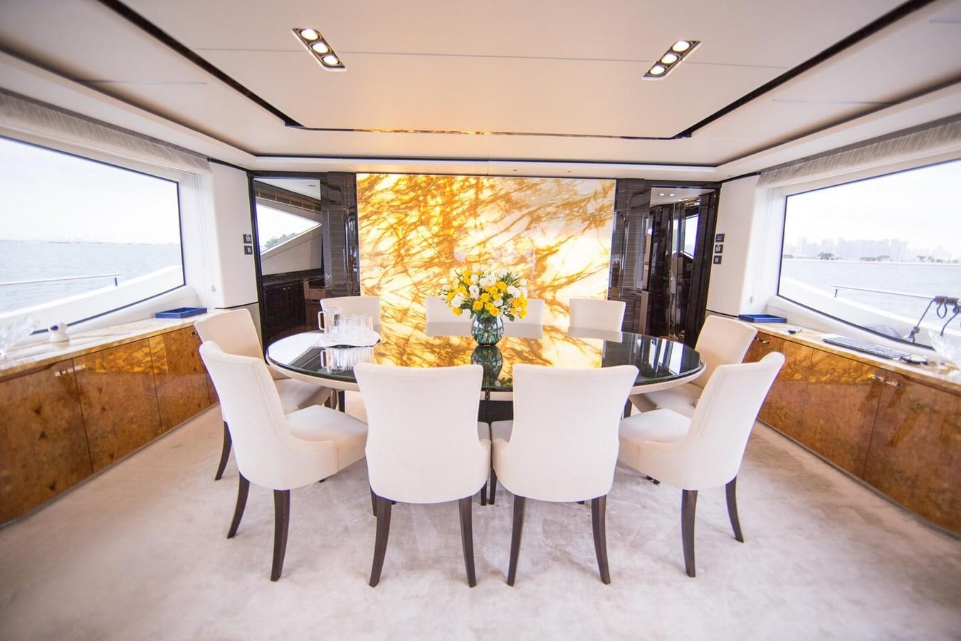 a dining room table with white chairs aboard THE SPIRIT OF ELIJAH Yacht for Sale