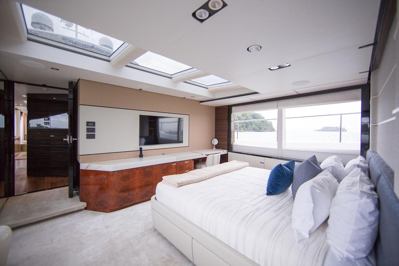 a bedroom with a bed and a television aboard THE SPIRIT OF ELIJAH Yacht for Sale