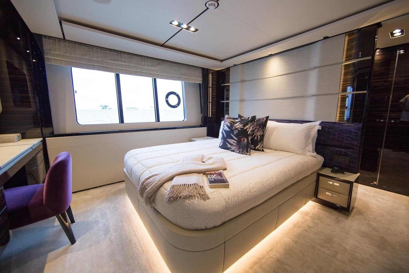 a bedroom with a bed and a window aboard THE SPIRIT OF ELIJAH Yacht for Sale