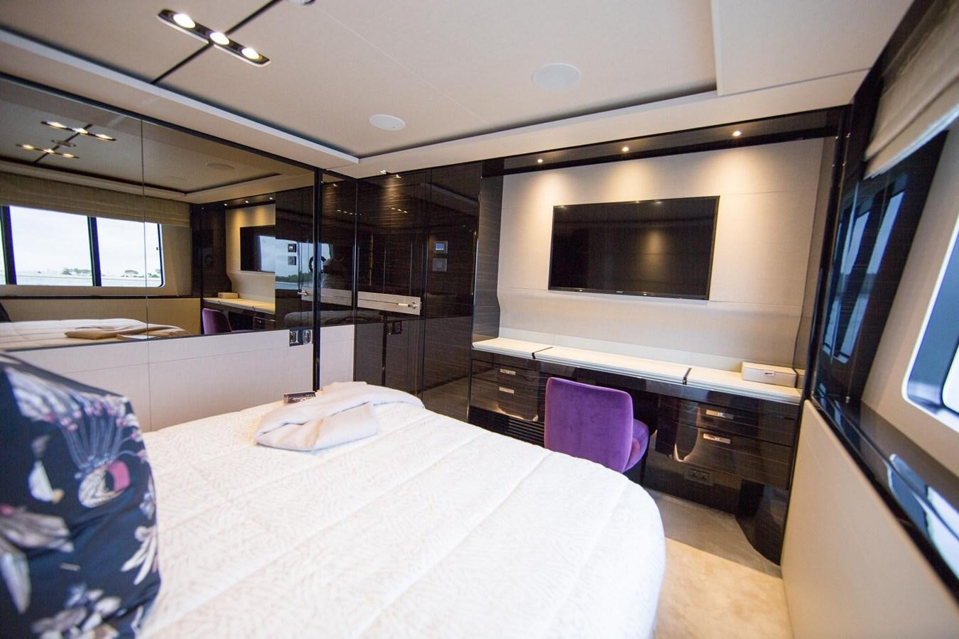 a bedroom with a tv and a bed aboard THE SPIRIT OF ELIJAH Yacht for Sale
