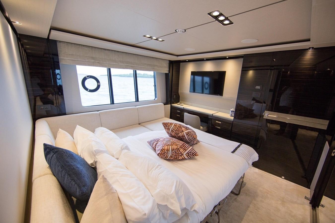 a bedroom with a bed and a television aboard THE SPIRIT OF ELIJAH Yacht for Sale