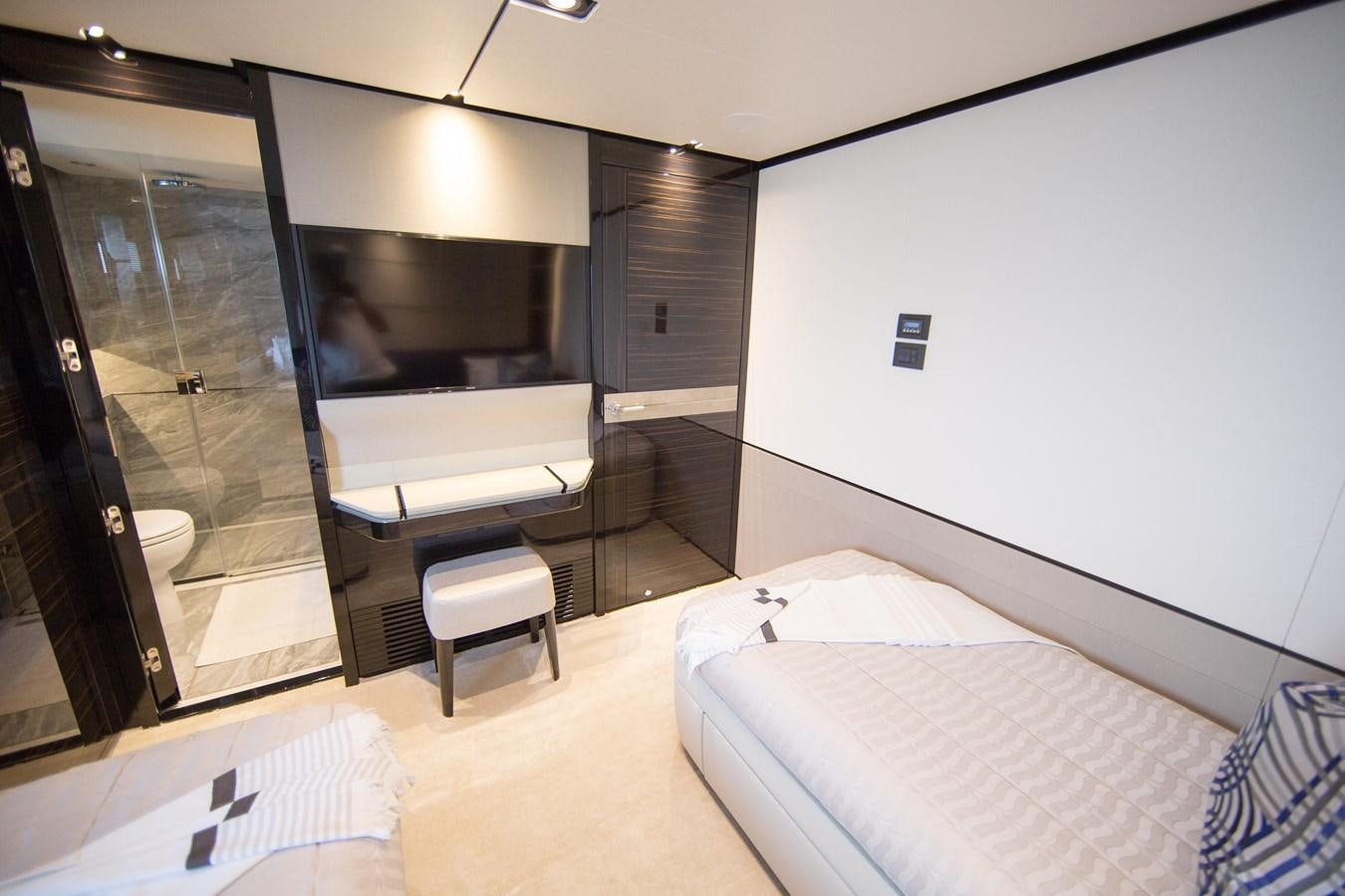 a hotel room with a bed and a large mirror aboard THE SPIRIT OF ELIJAH Yacht for Sale