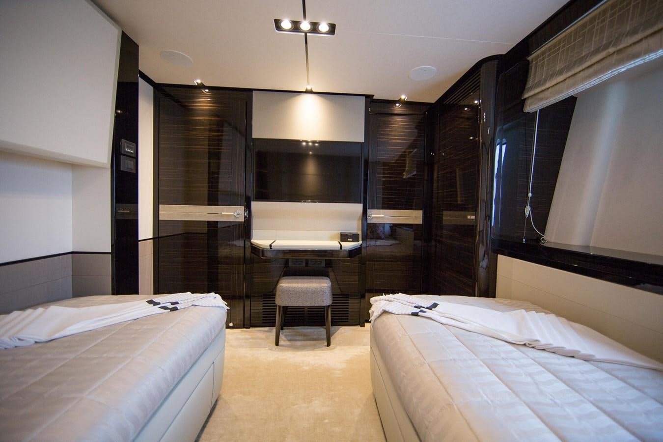 a room with a bed and a desk aboard THE SPIRIT OF ELIJAH Yacht for Sale