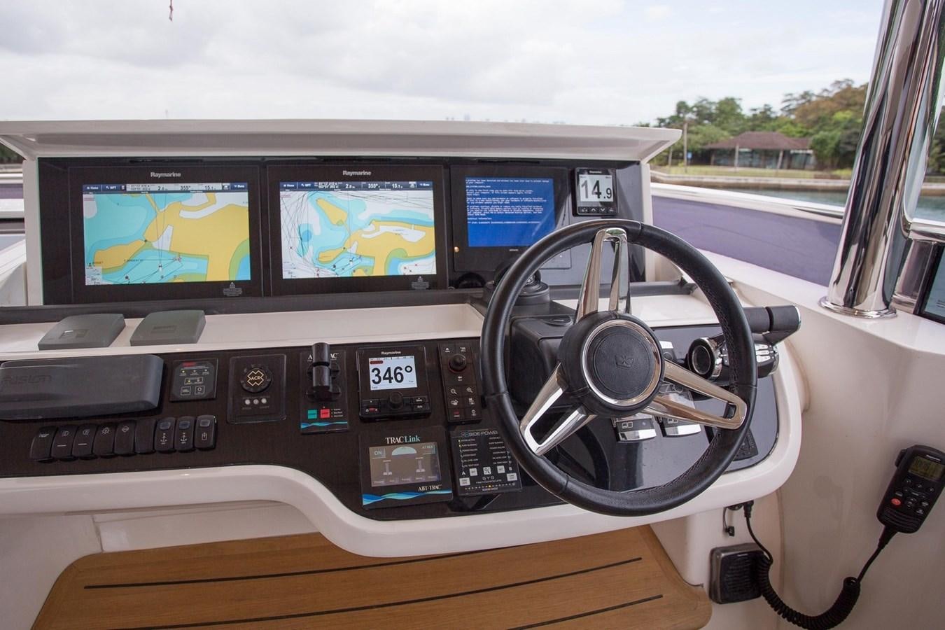 a car dashboard with a screen and a steering wheel aboard THE SPIRIT OF ELIJAH Yacht for Sale
