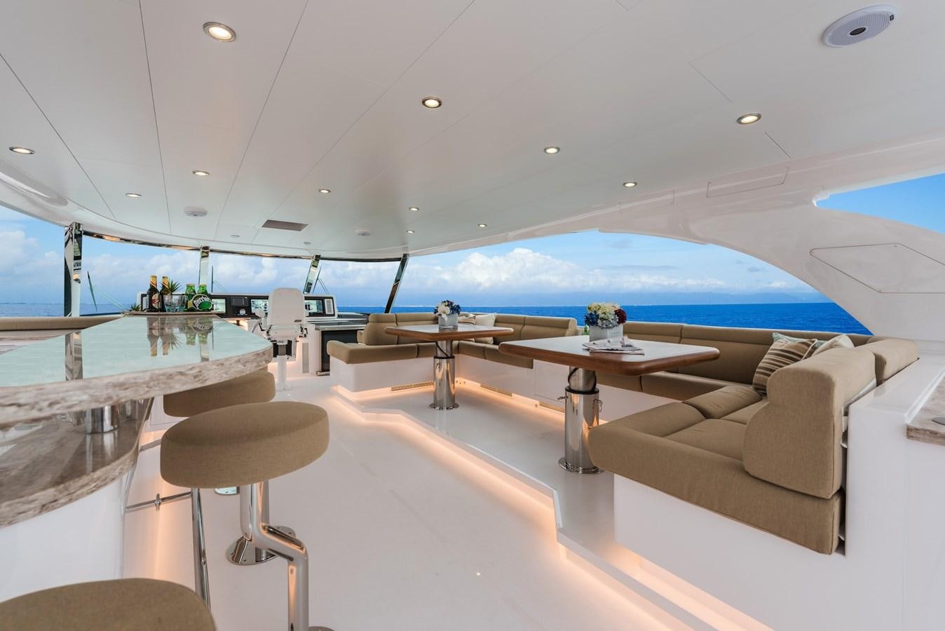 a room with a couch and a table and a large window aboard E100 (NEW SPEC BOAT)  Yacht for Sale