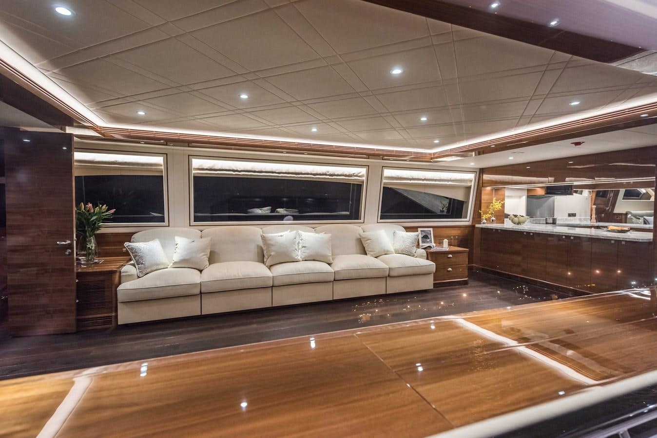 a living room with a couch and a large mirror aboard E100 (NEW SPEC BOAT)  Yacht for Sale