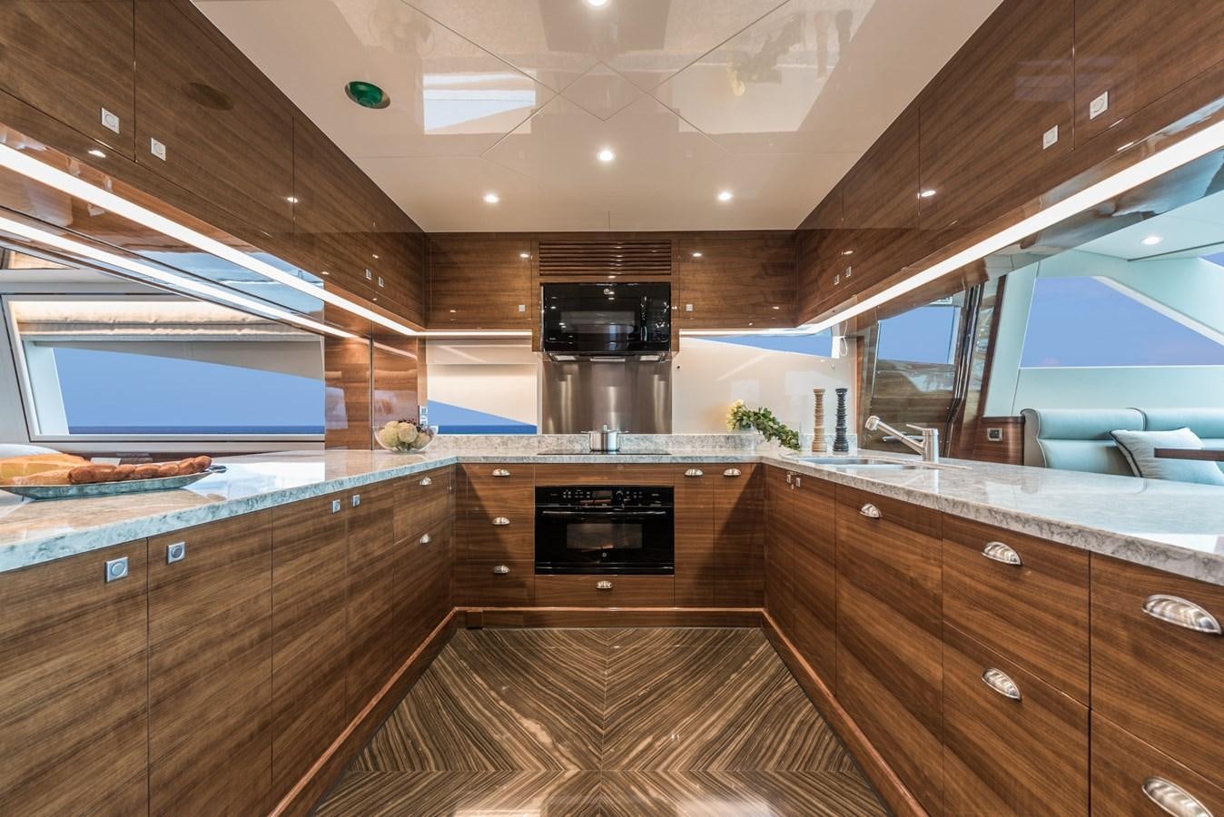 a kitchen with a large island aboard E100 (NEW SPEC BOAT)  Yacht for Sale