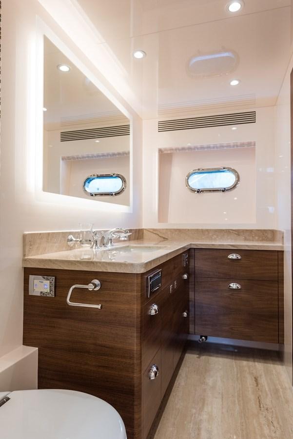 a bathroom with a sink and a mirror aboard E100 (NEW SPEC BOAT)  Yacht for Sale