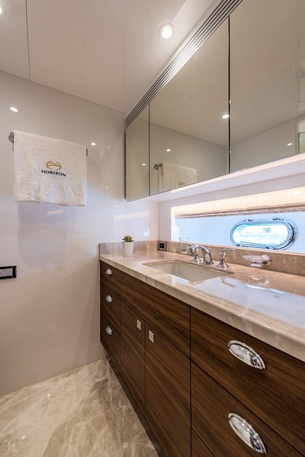 a bathroom with a sink and a tv aboard E100 (NEW SPEC BOAT)  Yacht for Sale