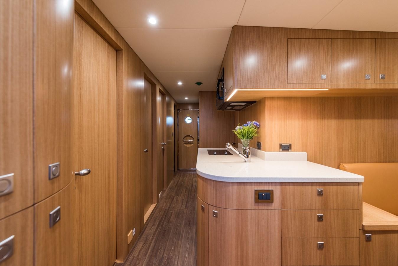 a kitchen with wooden cabinets aboard E100 (NEW SPEC BOAT)  Yacht for Sale