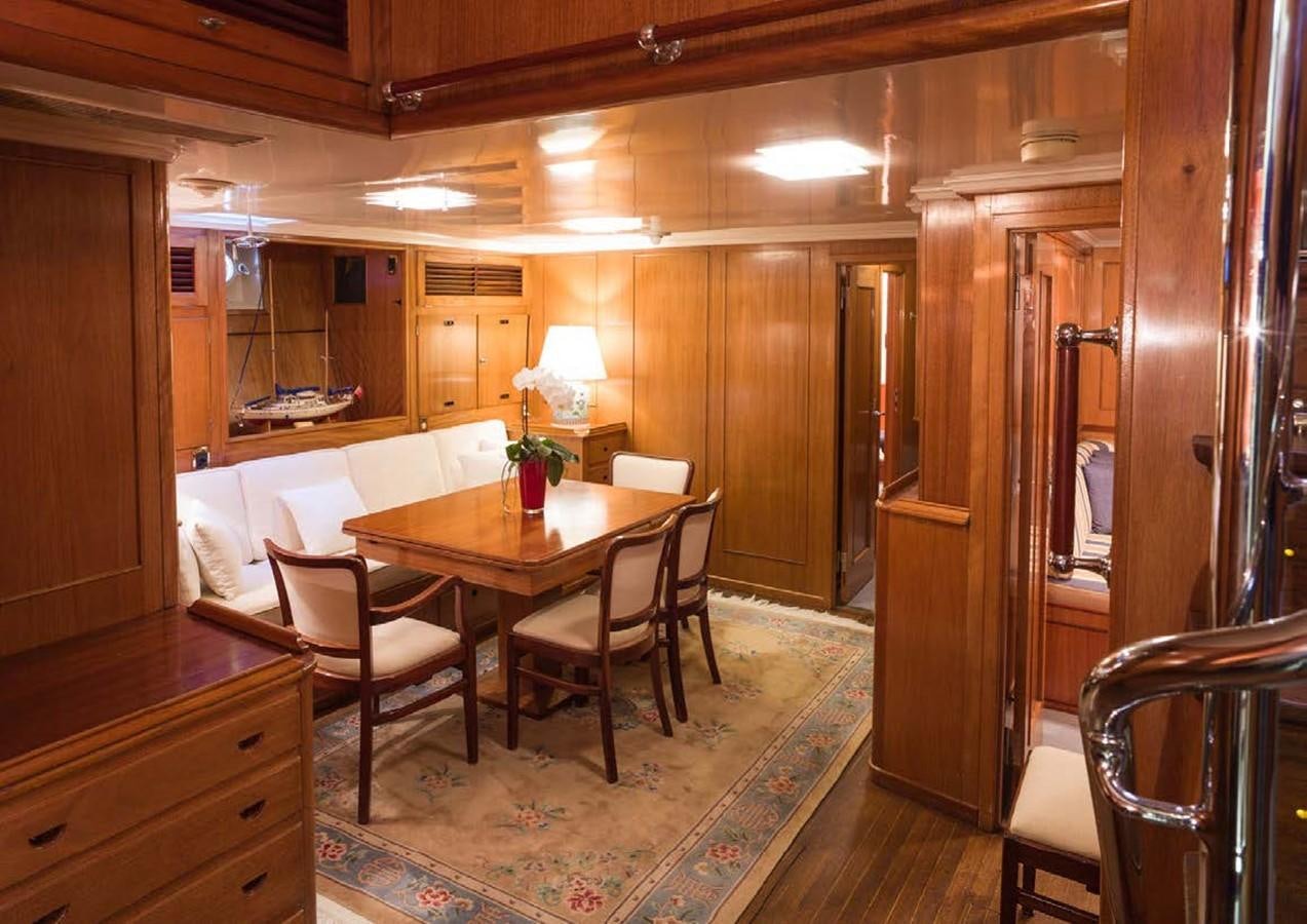 a room with a table chairs and a couch aboard FEI-SEEN Yacht for Sale