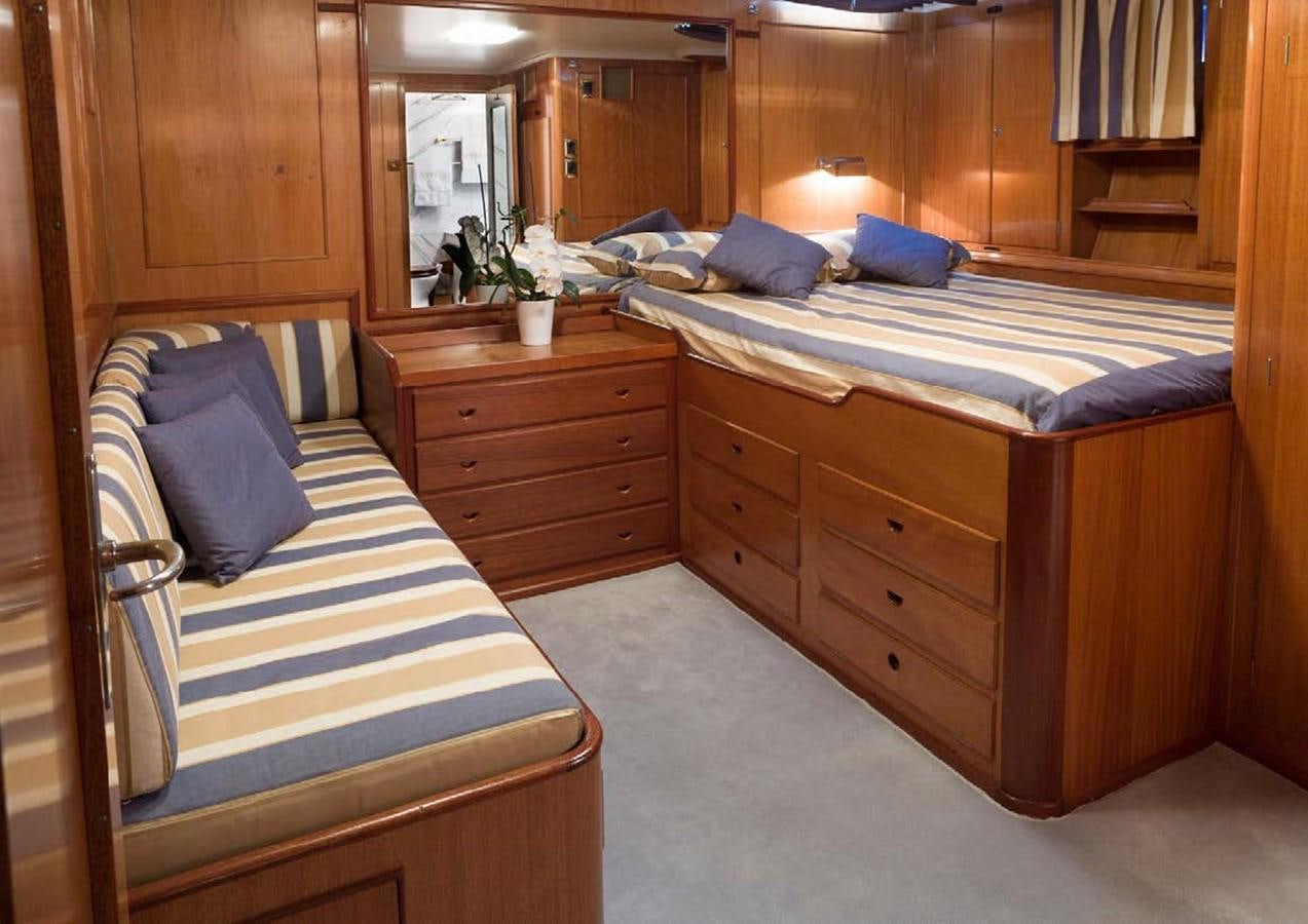 a bedroom with a bed and a dresser aboard FEI-SEEN Yacht for Sale