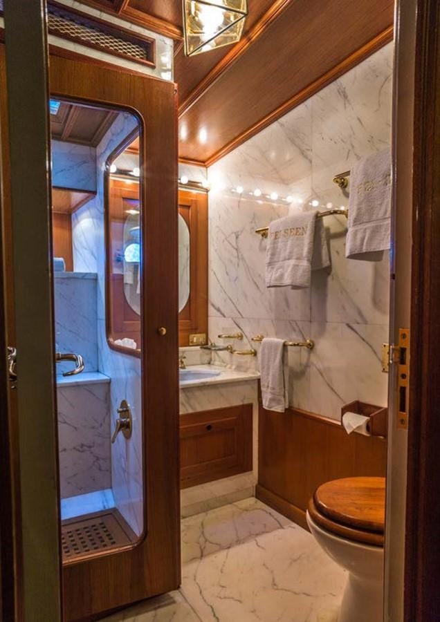 a bathroom with a glass shower door aboard FEI-SEEN Yacht for Sale